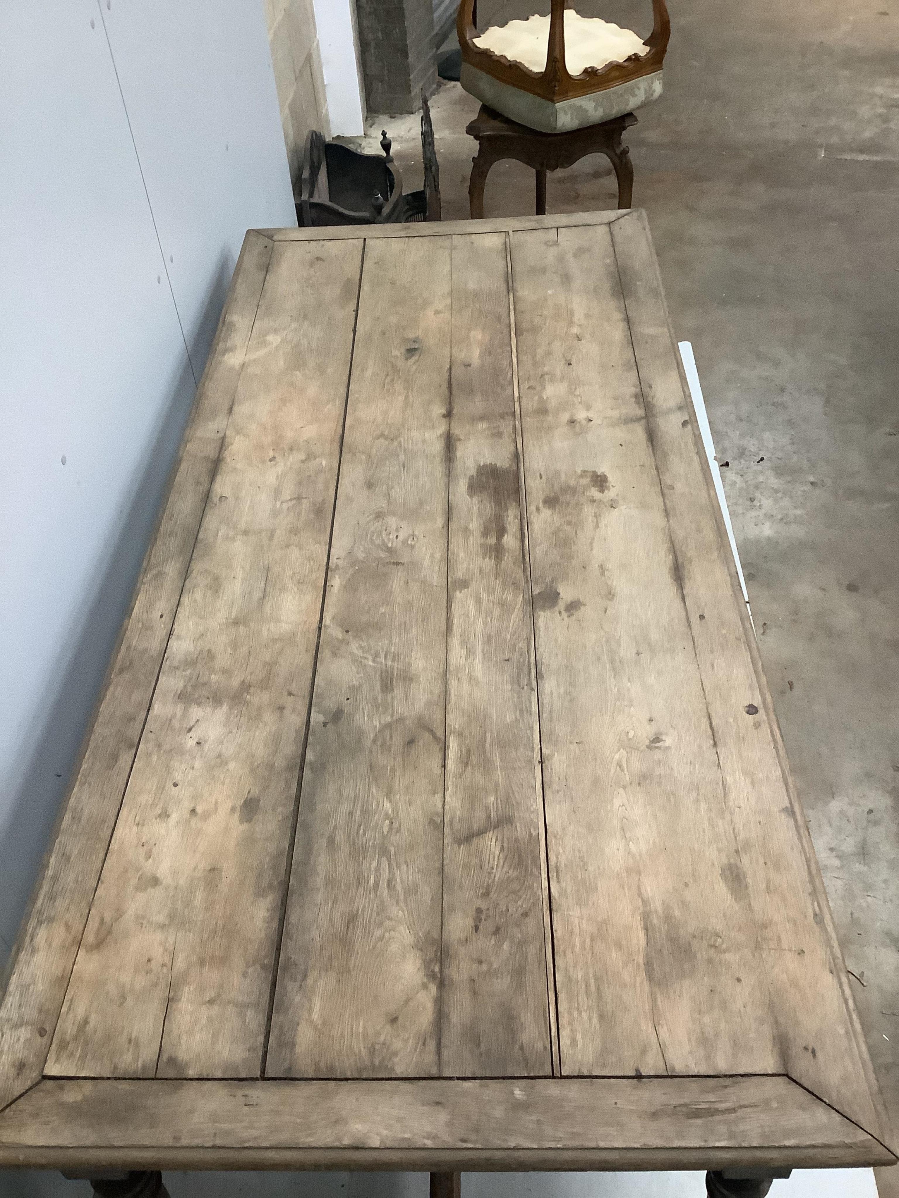 A 19th century French rectangular oak kitchen table, one side drawer and two end drawers, width 199cm, depth 90cm, height 76cm. Condition - poor to fair